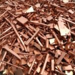 Copper scrap and raw copper materials representing commodity pricing in the electrical supply market.