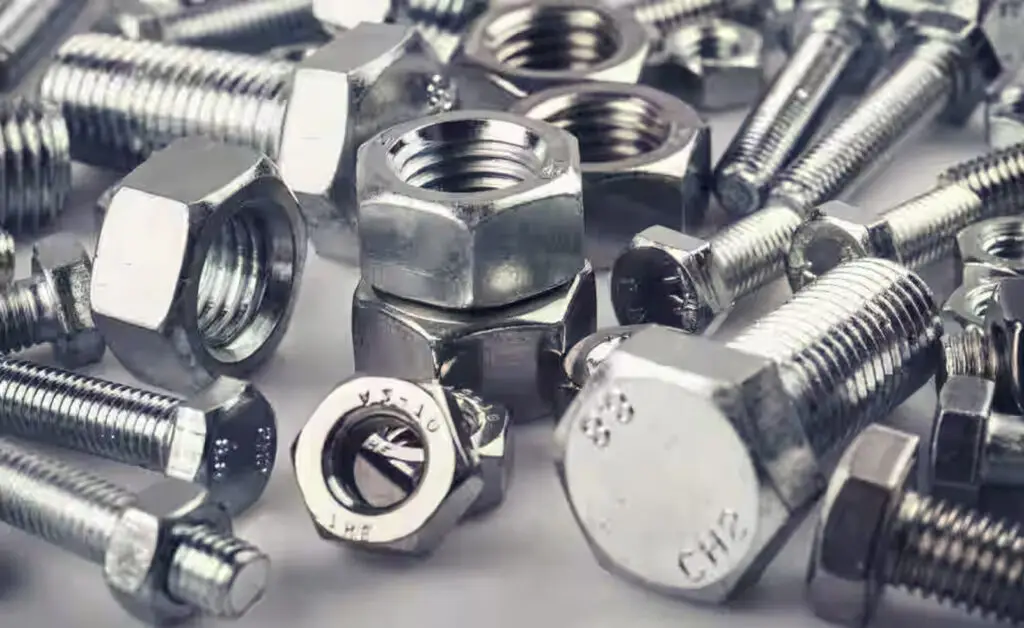 Close-up of assorted galvanized hex bolts, nuts, and threaded industrial fasteners